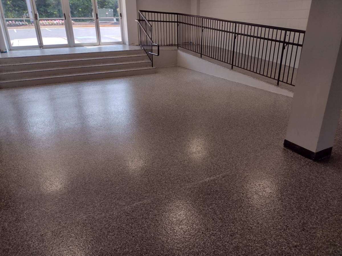 School lobby with a flake floor continued up the stairs and ramp