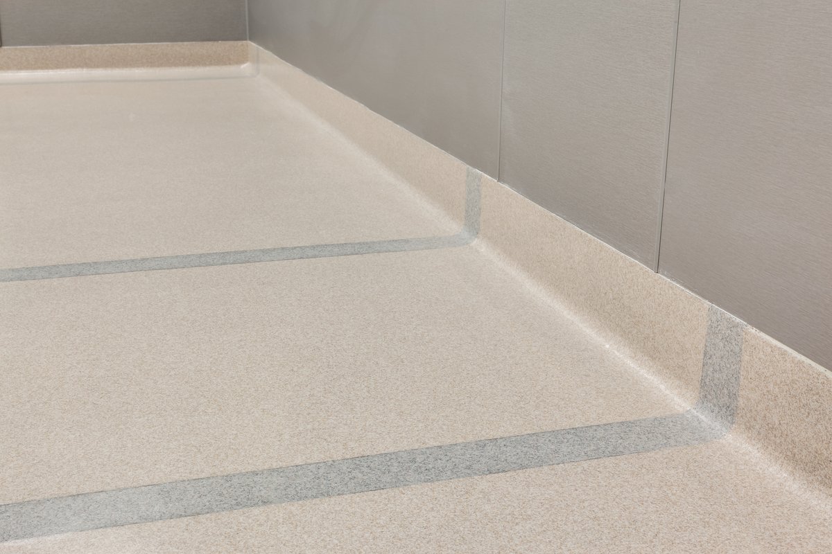 Integral cove base running along a wall