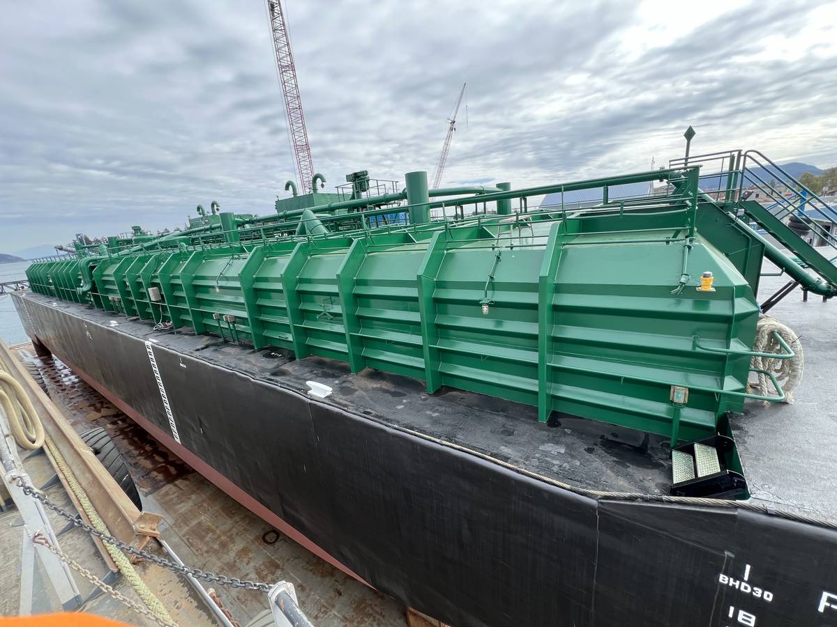 Barge bow with coated hull and green deck structures